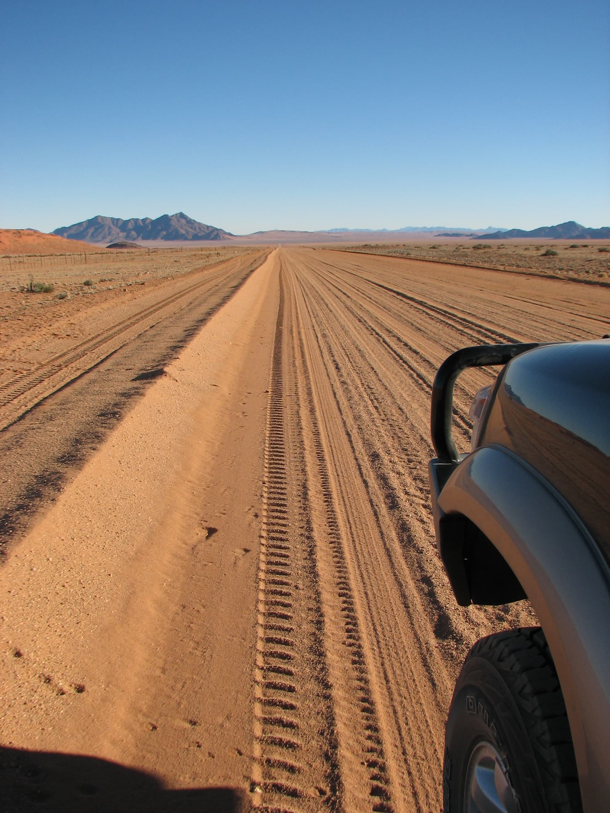 Namibia gravel road stretching into the distance — the open road
